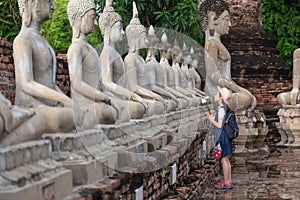 Asian girl tourist holding a lotus with respecting or pray