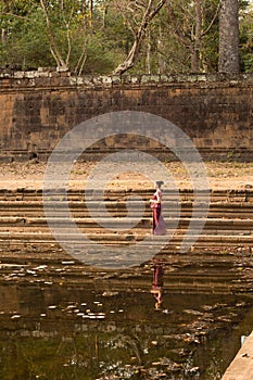 Asian Girl in Traditional Dress by a Pool of Water in Angkor