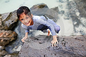 Asian girl training skills and practice rock climbing