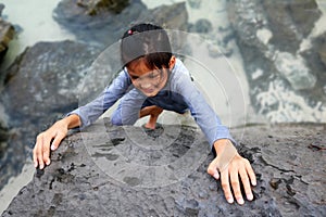 Asian girl training skills and practice rock climbing