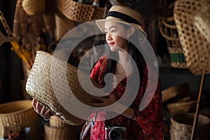 Asian girl, travel and shopping in traditional basketry shop