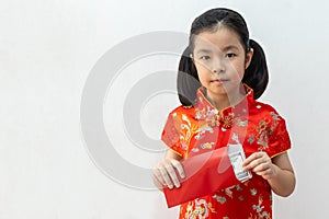 Asian girl wear cheongsam and take Red envelopes in chinese new year