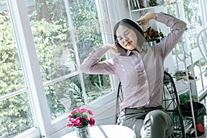 Asian girl Wear a t-shirt, wear glasses, and sit lazily around during the day. On a normal, tired day