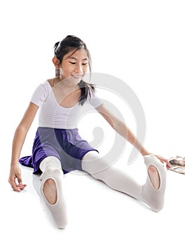 Asian girl wearing ballet shoes on white background.