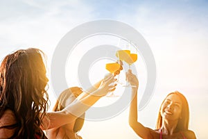 Asian girl wearing bikini holding a glass of orange juice