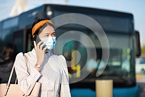 Asian girl wearing face mask at the bus station