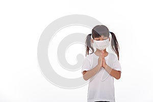 Asian girl wearing mask for protect pm2.5 and coronavirus Covid-19.Stay at home praying to GOD.Online church worship in sunday.