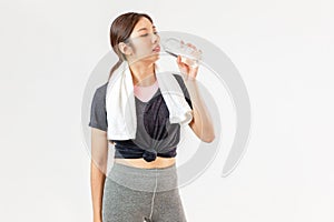 Asian girl wearing sportwear holding drinking water looking camera