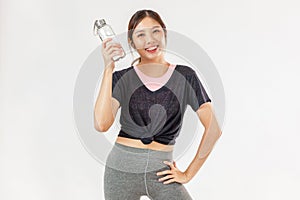 Asian girl wearing sportwear holding drinking water looking camera