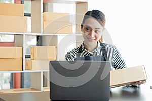 Asian girl working with boxes at home office small business owner start up Entrepreneur, small business, SME or self