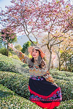 Asian girls in the cherry blossom bushes in spring