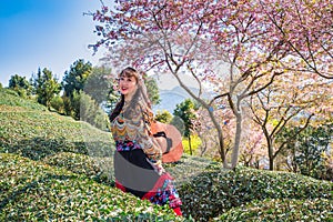 Asian girls in the cherry blossom bushes in spring