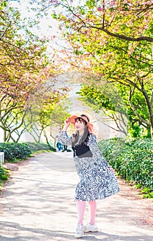 Asian girls in the cherry blossom bushes in spring