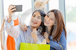 Asian girls with friend happy enjoy shopping happiness moment fun selfie in shop together