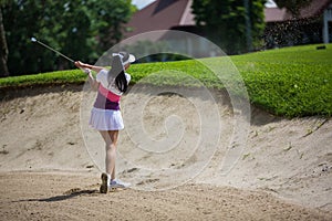 Asian girls are playing golf on a sunny day