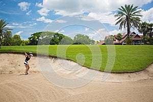 Asian girls are playing golf on a sunny day