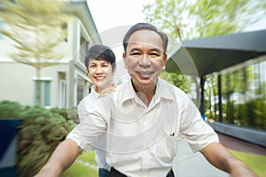 Asian grandfather and grandmother take exercise by bicycle togather in they village