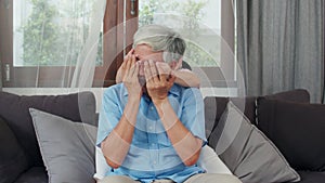 Asian grandfather relax at home. Senior Chinese, grandpa happy relax with young granddaughter girl enjoy close his eyes surprise