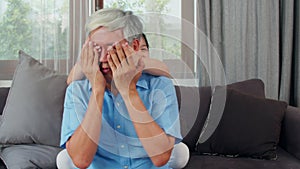 Asian grandfather relax at home. Senior Chinese, grandpa happy relax with young granddaughter girl enjoy close his eyes surprise