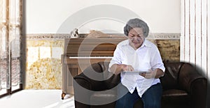 Asian grandmother chating online with tablet