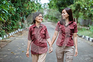 Asian grandmother enjoy chatting with her daughter`s when walking