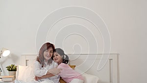 Asian grandmother granddaughter relax at home. Senior Chinese, grandma happy relax with young girl jump enjoy playing together
