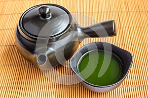 Asian Green tea set on bamboo mat