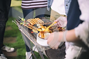 Asian group of Friends making barbecue and grilled shashliks on