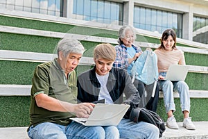 Asian group student, old age and young sitting on the stairs