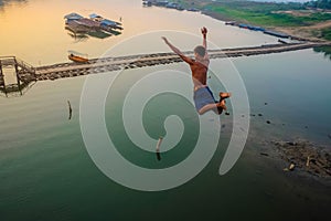 Asian Guy Jump from Mon Bridge in sangkhlaburi kanchanaburithailand