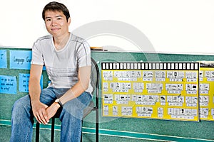 Asian guy sitting on a chair in a laboratory