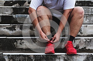 Asian Guy Tying Running Shoe, Preparing to Running for Losing Weight