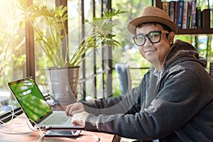 Asian Hacker using laptop and computers in cafe.