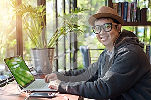 Asian Hacker using laptop and computers in cafe.