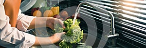 Asian hands woman washing vegetables salad and preparation healthy food in kitchen