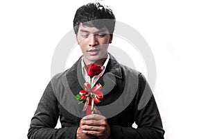 Asian handsome man hold the red rose with love