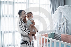 Asian happy baby on the crib