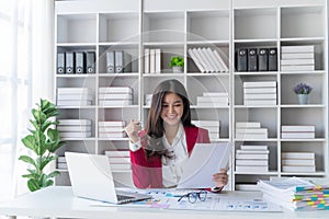 Asian happy beautiful businesswoman in formal suit work in workplace. Attractive female employee office worker smile