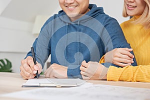 Asian happy couple getting key and handshake with realtor agent with smiling face at new home.buying new house real estate