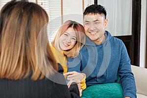 Asian happy couple getting key and handshake with realtor agent with smiling face at new home.buying new house real estate