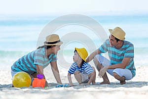 Asian happy family have fun on the beach.  Traveling backpack for travel in vacations for leisure