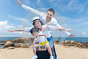 Asian happy family have fun on the beach.  Traveling backpack for travel in vocations for leisure and destination.