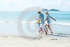 Asian happy family have fun and running relax on the beach for leisure and destination.  Family people tourism travel enjoy in sum