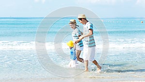 Asian happy family have fun water sea on the beach. Parent and daughter traveling