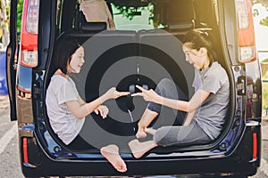 Asian happy Girl playing Rock paper scissors game on car