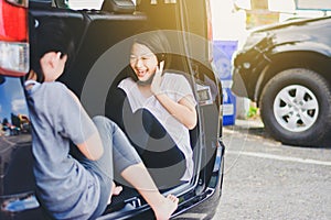 Asian happy Girl playing Rock paper scissors game on car