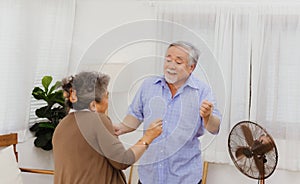 Asian happy retired senior smiling cute eldery couple enjoying & laughing dancing together in home. Romantic relationship of