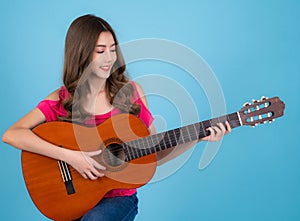 Asian happy singer woman sit on bar chair and sing a song with acoustic guitar