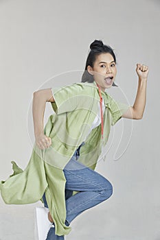 Asian happy woman running isolated over white background