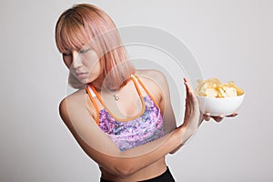 Asian healthy girl hate potato chips, junk food.